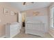 Well-appointed Bedroom with white crib, dresser, and attached bathroom at 860 Cokesbury Rd, Fuquay Varina, NC 27526