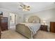 Cozy main bedroom with a decorative ceiling fan, neutral paint, and adjoining bathroom at 860 Cokesbury Rd, Fuquay Varina, NC 27526