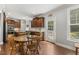 Dining area with kitchen in background, featuring hardwood floors at 860 Cokesbury Rd, Fuquay Varina, NC 27526