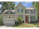 Charming two-story home with blue shutters, a red front door, and a well-manicured lawn at 860 Cokesbury Rd, Fuquay Varina, NC 27526