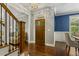 Elegant foyer with hardwood floors, stairs, and a view into the dining room and living area at 860 Cokesbury Rd, Fuquay Varina, NC 27526