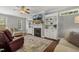 Bright living room featuring built-in bookshelves, a fireplace, and lots of natural light at 860 Cokesbury Rd, Fuquay Varina, NC 27526