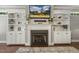 Living room showcasing fireplace with built-ins and a mounted television at 860 Cokesbury Rd, Fuquay Varina, NC 27526