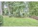 Lush backyard featuring mature trees, offering a serene and private outdoor retreat at 102 Duxbury Dr, Cary, NC 27513
