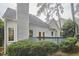 Rear exterior of the home showcasing a private deck surrounded by mature landscaping at 102 Duxbury Dr, Cary, NC 27513