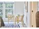Cozy bedroom nook featuring two light wood chairs flanking a window, creating a serene and inviting reading space at 102 Duxbury Dr, Cary, NC 27513