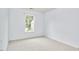 A bedroom with blue walls, gray carpet, and a large window at 102 Duxbury Dr, Cary, NC 27513