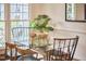 Bright breakfast nook with a glass table, black wire chairs, and natural light at 102 Duxbury Dr, Cary, NC 27513