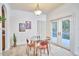 Dining area features a glass table, modern chairs, and access to outdoor deck at 102 Duxbury Dr, Cary, NC 27513