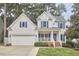Charming two-story home with a well-manicured lawn, two-car garage, and inviting front porch at 102 Duxbury Dr, Cary, NC 27513