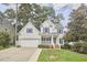 Charming two-story home with a well-manicured lawn, attached two-car garage, and inviting front porch at 102 Duxbury Dr, Cary, NC 27513