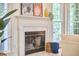Living room featuring fireplace with marble surround and art above mantle at 102 Duxbury Dr, Cary, NC 27513