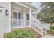 Cozy front porch featuring a seating area and a welcoming entrance with brick steps at 102 Duxbury Dr, Cary, NC 27513