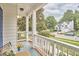 Charming front porch with wicker furniture and a view of the peaceful neighborhood at 102 Duxbury Dr, Cary, NC 27513