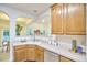 Open concept kitchen features wooden cabinets, updated countertops, and seamless connection to the light filled living area at 102 Duxbury Dr, Cary, NC 27513