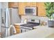Modern kitchen showcasing stainless steel appliances, wood cabinets, and an efficient layout at 102 Duxbury Dr, Cary, NC 27513
