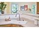 Bright kitchen with stainless steel faucet, white countertops, and a seamless view into an adjacent living space at 102 Duxbury Dr, Cary, NC 27513