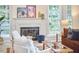 Cozy living room with fireplace, comfortable seating, and ample natural light at 102 Duxbury Dr, Cary, NC 27513