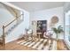 Cozy living room features hardwood floors, and a staircase with white risers at 102 Duxbury Dr, Cary, NC 27513