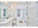 Spa-like bathroom with dual sinks, a glass-enclosed shower, and luxurious marble-style tiling at 102 Duxbury Dr, Cary, NC 27513