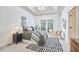 Inviting bedroom features a tray ceiling, a cozy bed, and sunlit reading nook, creating a relaxing retreat at 102 Duxbury Dr, Cary, NC 27513