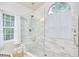 A marble tiled shower with glass door and tiled floor at 102 Duxbury Dr, Cary, NC 27513