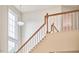 Staircase with wood handrail and natural light from large window at 102 Duxbury Dr, Cary, NC 27513