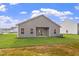 Spacious backyard with a covered patio and lush green lawn, perfect for outdoor activities at 107 Flue Ct, Oxford, NC 27565