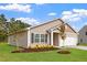 Charming home featuring stone accents, shutters, a two-car garage, and manicured lawn at 107 Flue Ct, Oxford, NC 27565