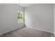 Standard bedroom with neutral gray walls, carpet flooring, a large window, and light-blocking blinds at 110 Hybrid St, Oxford, NC 27565