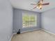 Carpeted bedroom with ceiling fan and large window at 1144 Dexter Ridge Dr, Holly Springs, NC 27540
