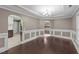 Dining area with hardwood floors, a modern chandelier, and convenient access to the kitchen at 1144 Dexter Ridge Dr, Holly Springs, NC 27540