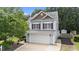 Charming two-story home with a two car garage, a well-maintained lawn and mature trees at 1144 Dexter Ridge Dr, Holly Springs, NC 27540