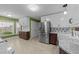 Bright, updated kitchen features stainless steel appliances and neutral tile flooring at 1144 Dexter Ridge Dr, Holly Springs, NC 27540
