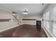 Open living room featuring a fireplace, hardwood floors and staircase leading to the second floor at 1144 Dexter Ridge Dr, Holly Springs, NC 27540