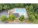 Aerial view of the neighborhood pool, surrounded by green trees and many lounge chairs and tables at 1144 Dexter Ridge Dr, Holly Springs, NC 27540