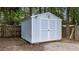 A light blue storage shed is located in the wooded backyard on a partial gravel foundation at 1144 Dexter Ridge Dr, Holly Springs, NC 27540