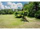Spacious backyard featuring lush greenery and a pergola, ideal for outdoor entertaining and relaxing at 125 Green Ln, Clayton, NC 27520