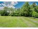 Expansive backyard featuring lush greenery and mature trees offering a serene outdoor space at 125 Green Ln, Clayton, NC 27520