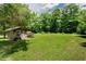 A well-maintained backyard with a shed and boat, offering ample space for outdoor activities and storage at 125 Green Ln, Clayton, NC 27520