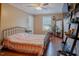 Cozy bedroom featuring a metal frame bed, hardwood floors, shelves, and plants at 125 Green Ln, Clayton, NC 27520
