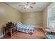 Small bedroom with hardwood floors, ample natural light from window, and ceiling fan at 125 Green Ln, Clayton, NC 27520