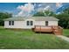 Charming single-story home with a well-maintained lawn and inviting front porch at 125 Green Ln, Clayton, NC 27520