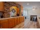 Spacious kitchen featuring stone accents, wood cabinets, modern appliances and hardwood flooring at 125 Green Ln, Clayton, NC 27520