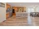 Open kitchen featuring an island, stainless steel appliances, and wood floors, ideal for entertaining at 125 Green Ln, Clayton, NC 27520