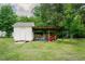 Outbuilding or shed with covered storage area in a well-kept backyard at 125 Green Ln, Clayton, NC 27520
