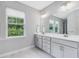 Bright bathroom with double vanity, modern fixtures, and a large window offering natural light and outdoor views at 128 Chapel Run Way, Chapel Hill, NC 27517