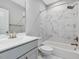Well-lit bathroom featuring a modern vanity, stylish mirror, and a shower-tub combo with elegant tile surround at 128 Chapel Run Way, Chapel Hill, NC 27517
