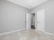 Clean and bright bedroom with neutral carpet and walls, and open doorway to another room at 128 Chapel Run Way, Chapel Hill, NC 27517
