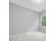 This bedroom has neutral carpeting and paint, plus a large window at 128 Chapel Run Way, Chapel Hill, NC 27517